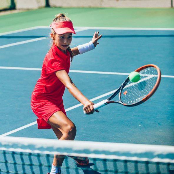 Teenage girl playing tennis